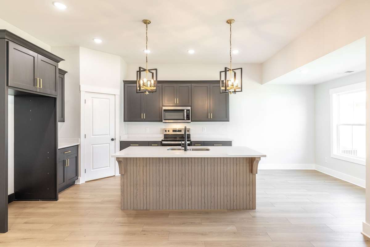 Kitchen has custom cabinetry with soft close hinges, white oak island, stainless appliances and designer fixtures~