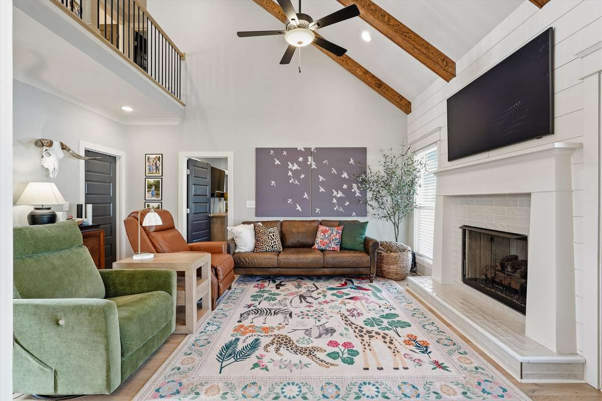 GAS FIREPLACE WITH SHIPLAP ACCENT WALL -- SOARING CEILINGS WITH BEAUTIFUL BEAMS