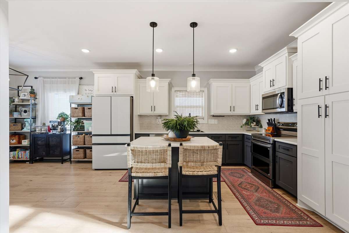 SELLER UPDATES TO THE KITCHEN: NEW FARMHOUSE SINK WITH GLASS RINSER, DOUBLE OVEN AND NEW LIGHTING