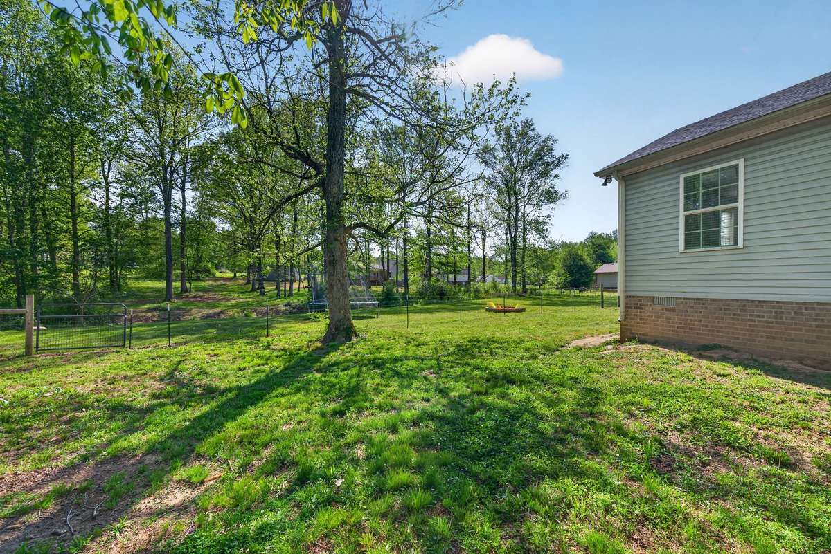 This backyard provides nice privacy with the mature trees