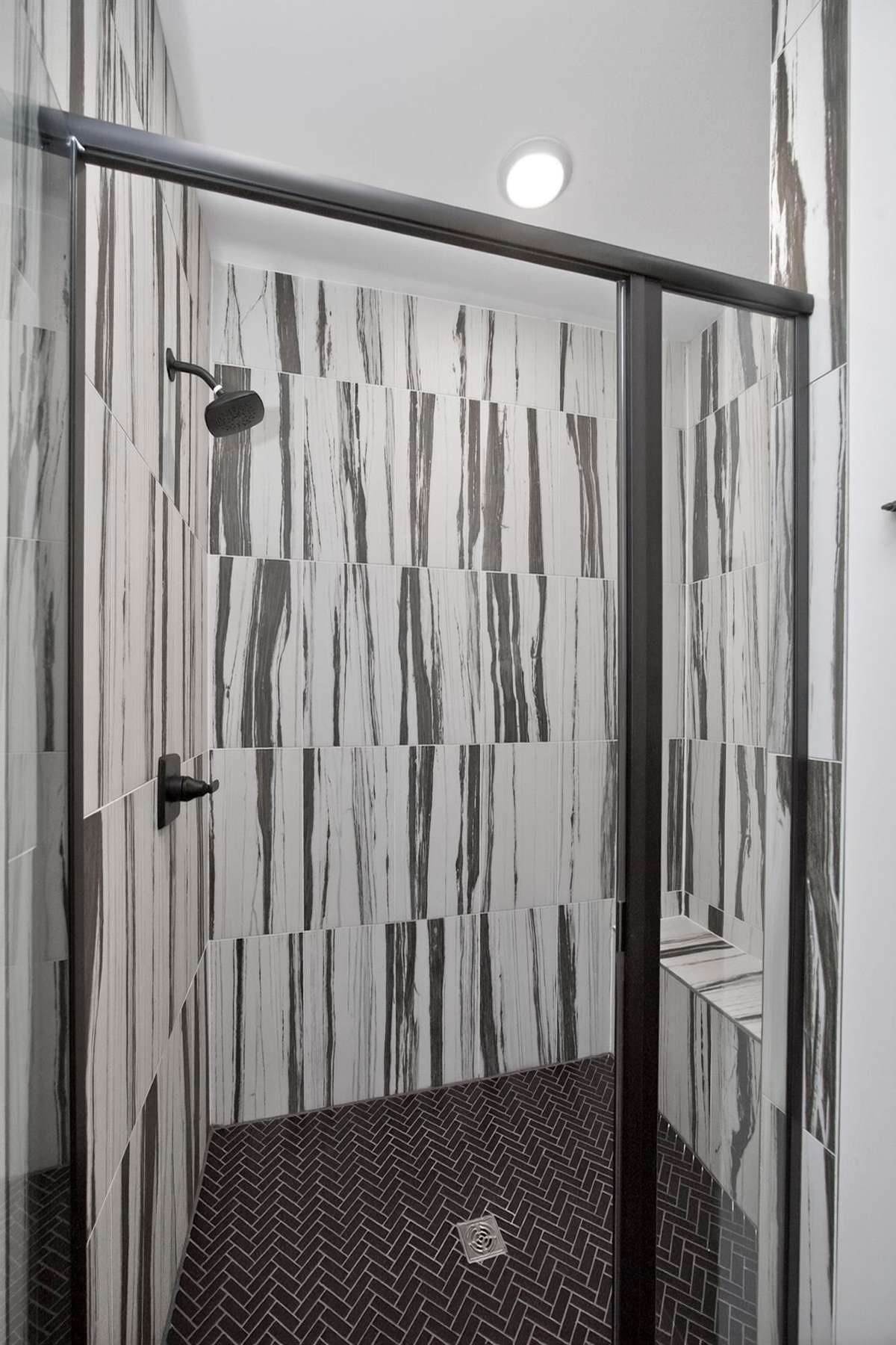 Striking tile in primary bathroom shower.