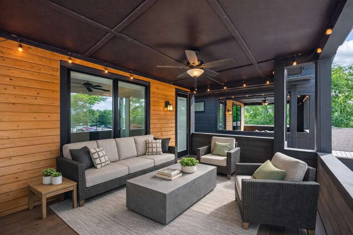 The huge covered second-story veranda, with its views of the tree-lined streets below, is a terrific setting for outdoor relaxation. Photo has been digitally staged.