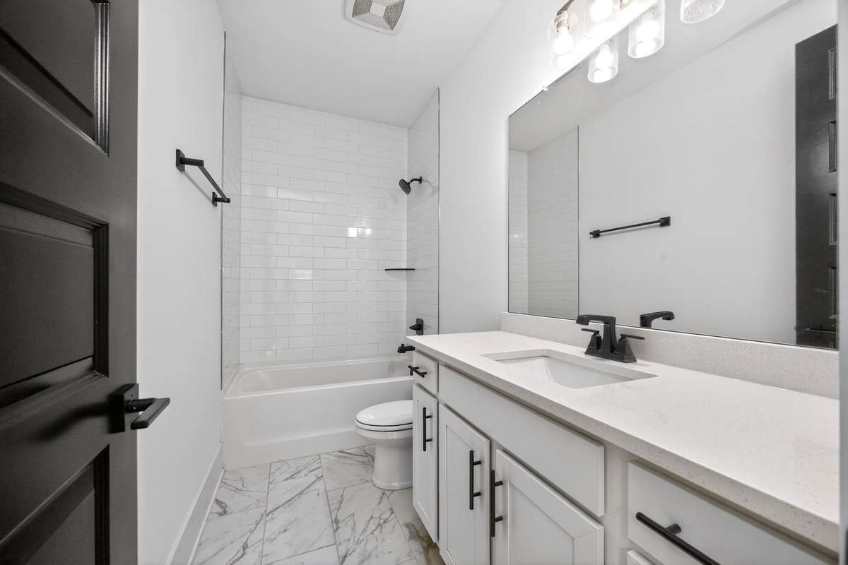 This full bath is located on the second floor, off of the hallway.