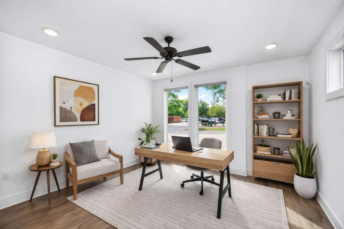 This main level bedroom offers flexibilty as a guest room or for use as a private office. Photo has been digitally staged.