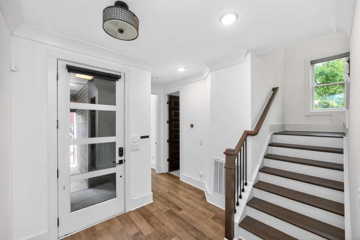 Upon entering, the rich hardwoods and abundant natural light create a beautiful first impression.