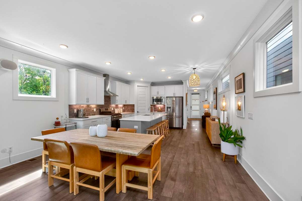 There is ample space for a large dining table in the area adjacent to the kitchen.