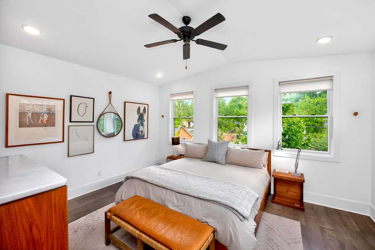 The high and vaulted ceiling creates a sense of airy spaciousness in the primary bedroom.