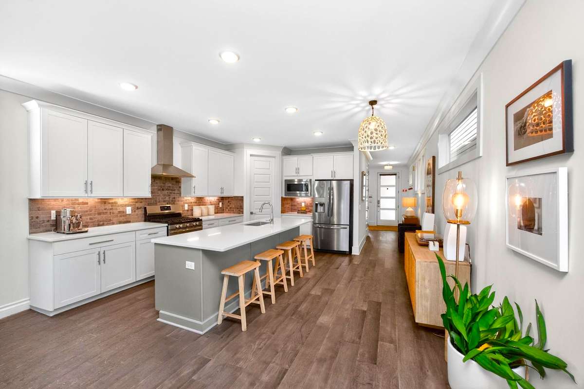 The over-sized island anchors the kitchen and can seat four comfortably.
