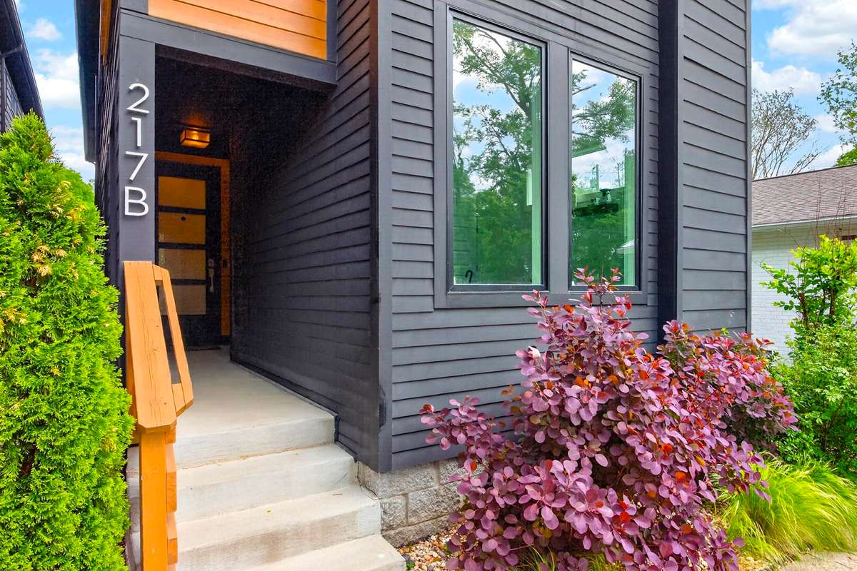 Attractive landscaping and a sheltered front porch invite you into the home, and a generous parking pad in front provides ample space for parking.