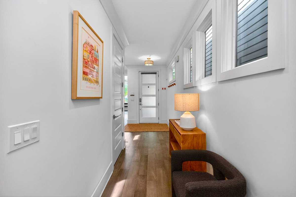 Upon entering, the rich hardwoods and abundant natural light create a beautiful first impression.