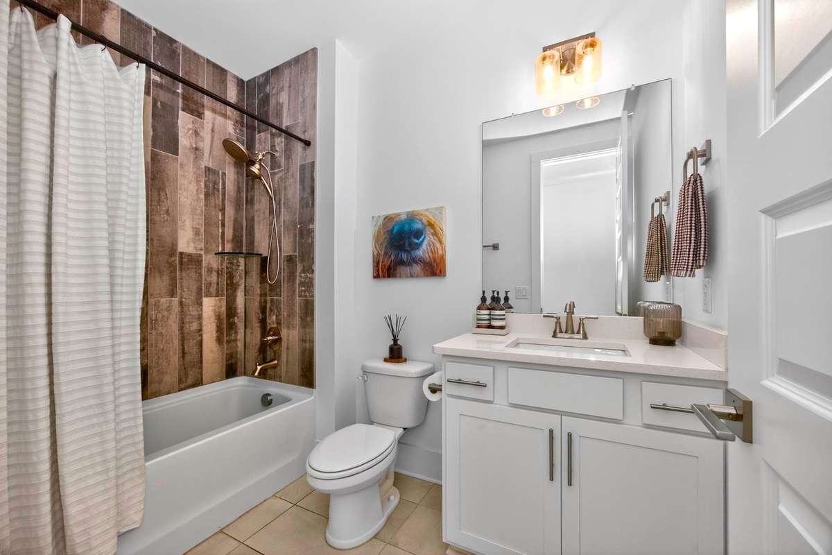 There is a full bath on the main level, with an attractive tiled shower.