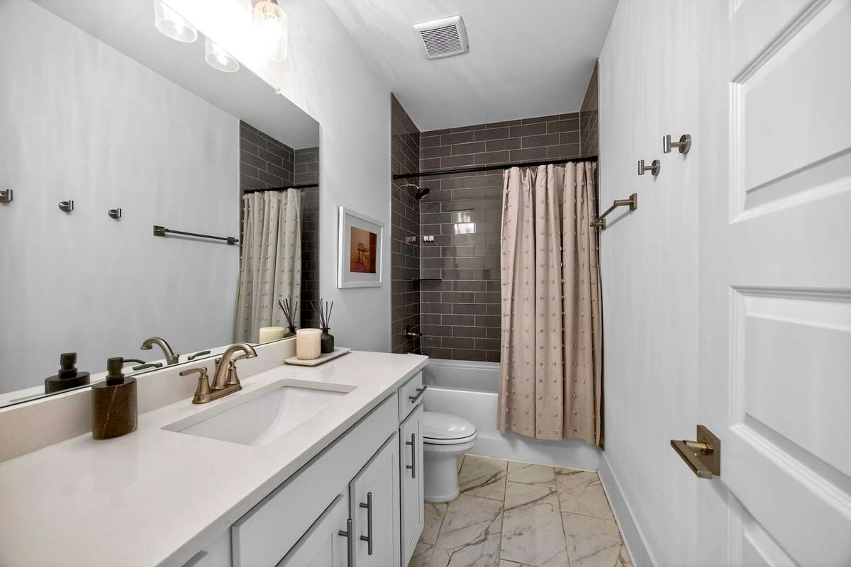 This full bath is located on the second floor, off of the hallway.