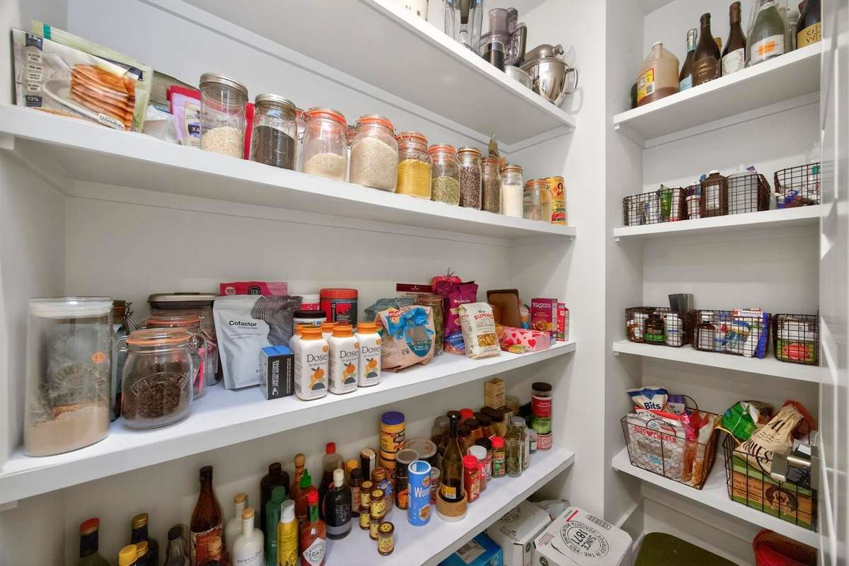 Large, walk-in pantry with plentiful built-in shelving.