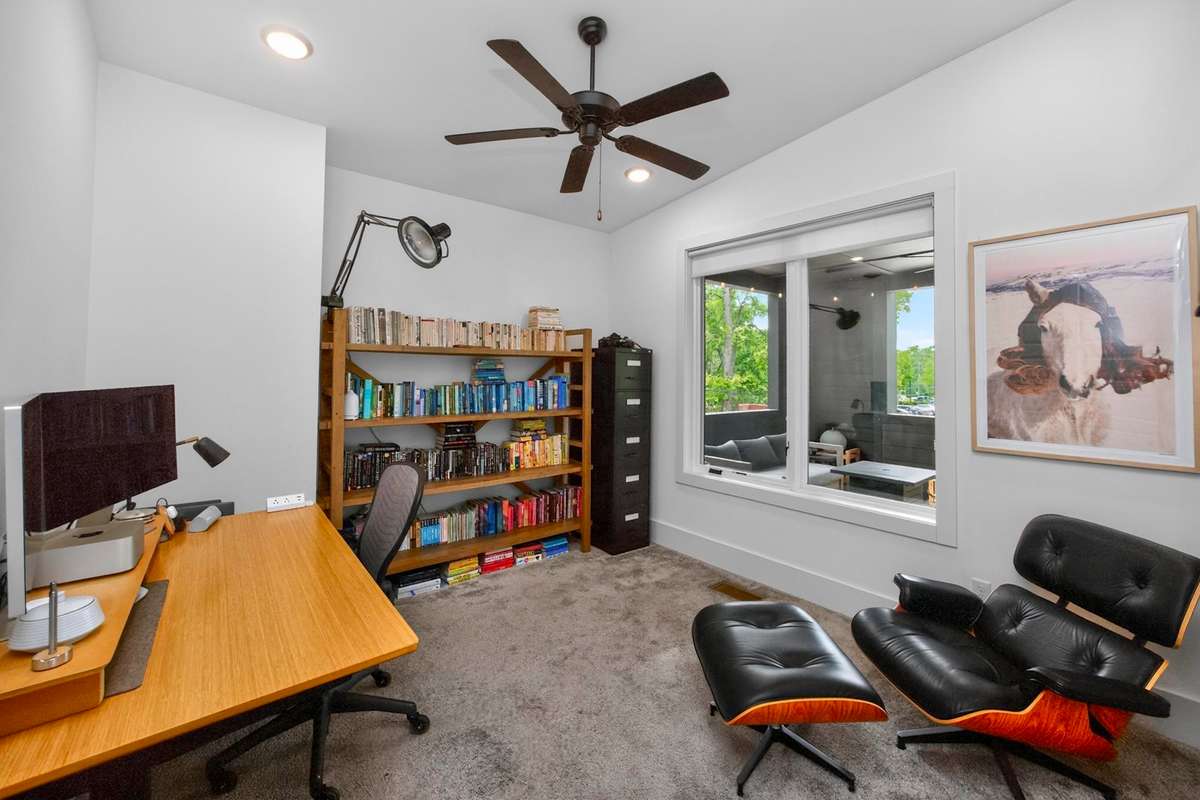 The third bedroom on the second level is located at the front of the house. Its windows look out onto the covered porch.