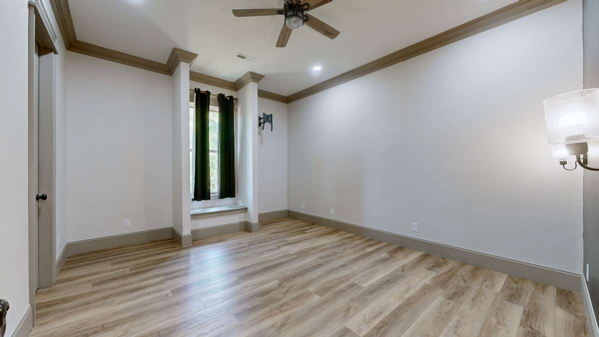 This is Bedroom 3 which has a window seat with a storage area under it.  There is a walk-in closet to the left also.