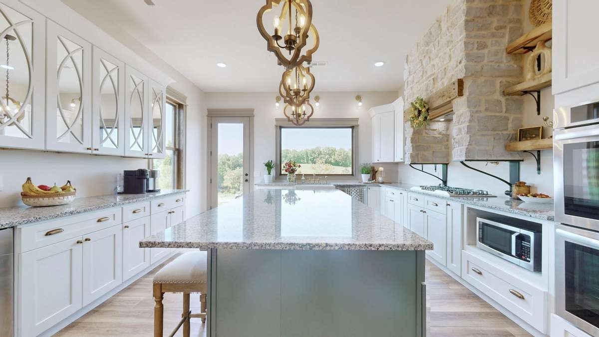 The Kitchen is amazing with Granite Counter tops, Double ovens, Gas Cooktop with Brick above it with the vent fan.