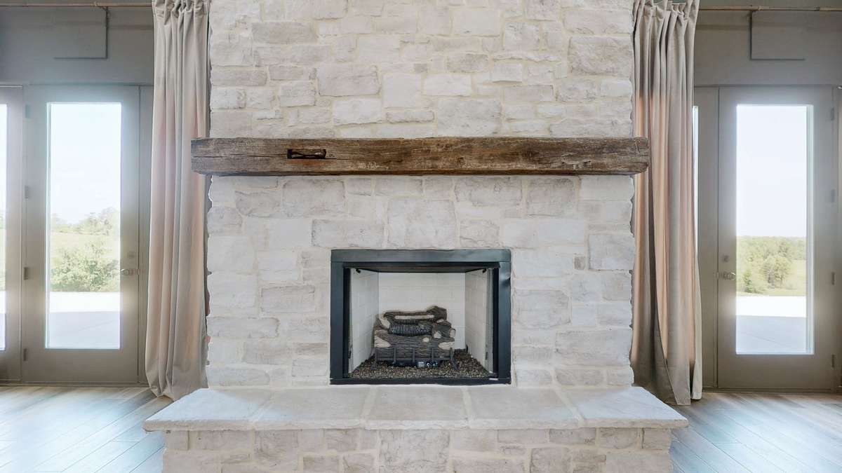 The fireplace is a gas-burning fireplace with entry doors on each side to the huge back patio.