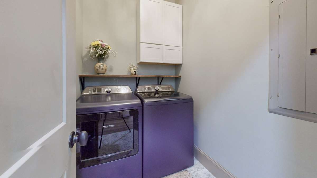 The Utiity room has some cabinets, a shelf and some extra space.