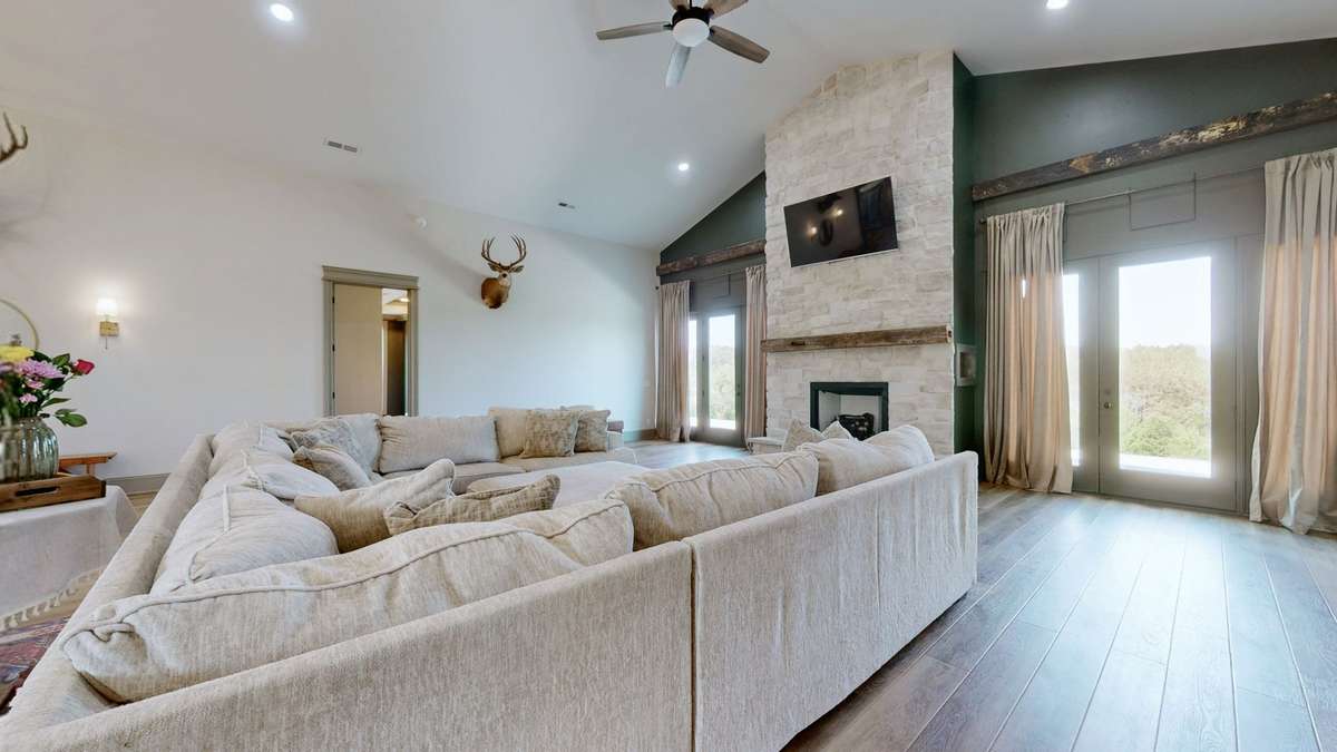 This is where people gather to watch tv with the cozy fireplace if the weather is cold.