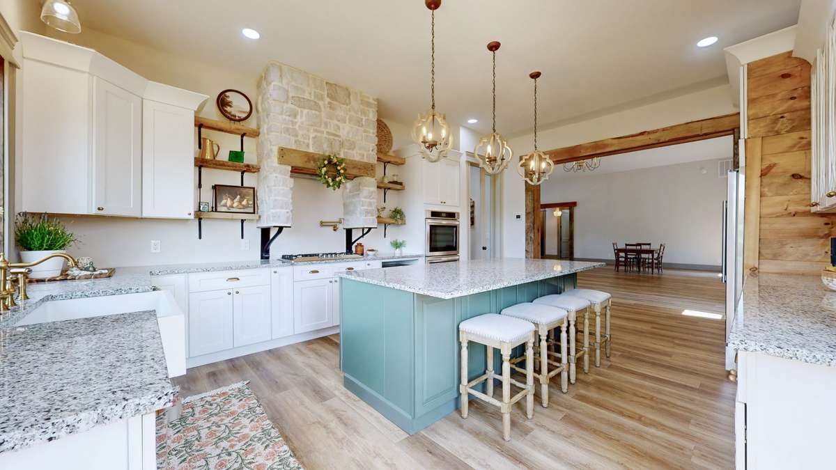 Gorgeous Kitchen with Granite Countertops, Farm sink, Stonework above the gas range, and so much more.