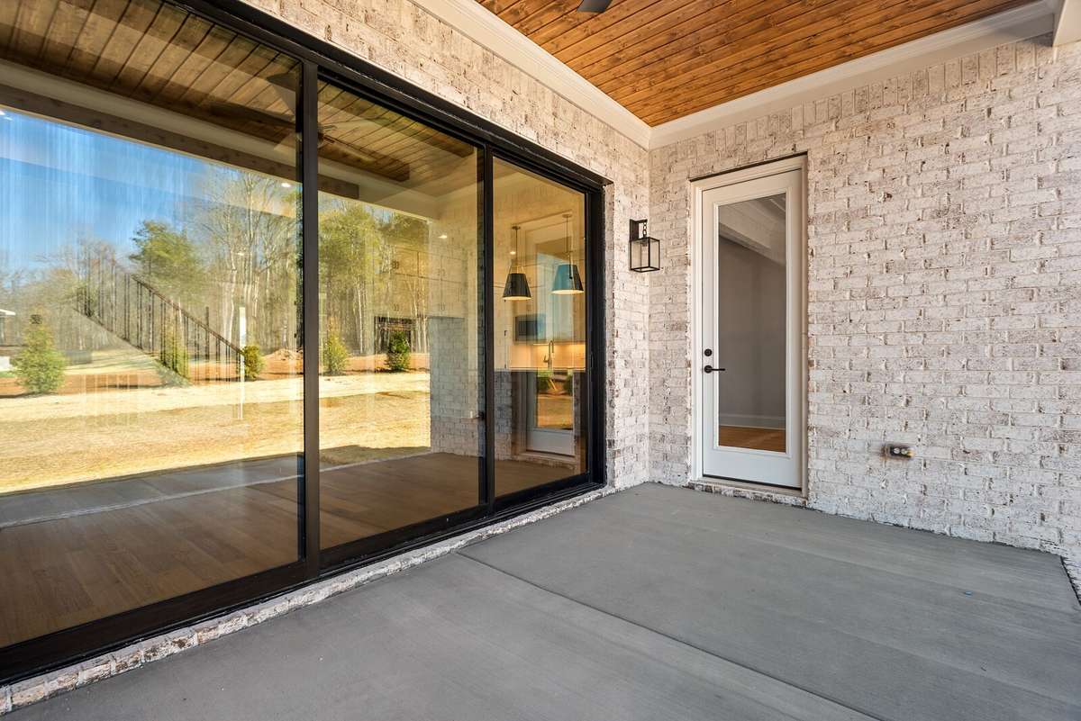 Bring the outdoors in by sliding back the doors in the Family room to your covered outdoor living area. Notice the stained cedar tongue and groove ceiling.
