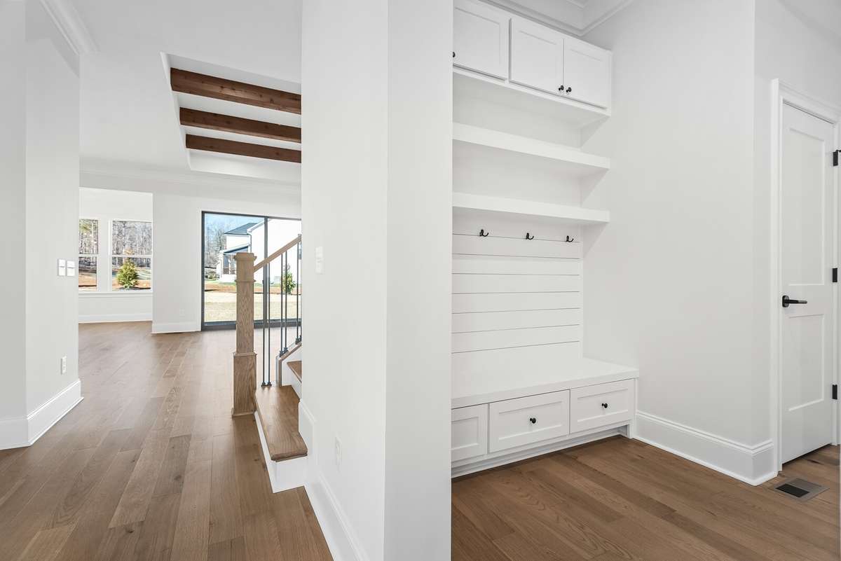 Located off of the main Foyer is a hallway to the Family Ready room and Drop Zone area which leads to the three car garage.