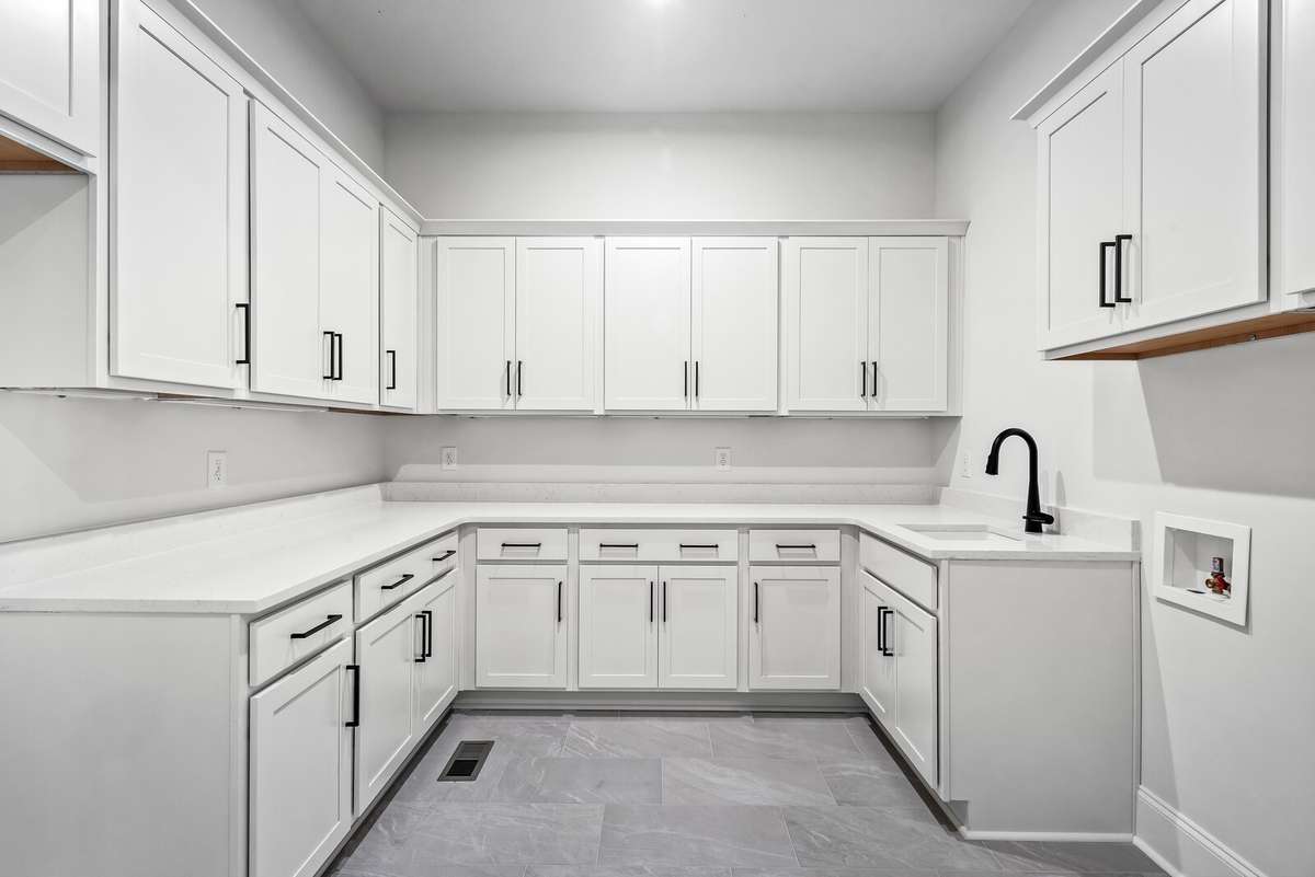 One favorite aspect of this home is the Family Ready room which is located off of the garage foyer.  Equipped with a water connection for a second, indoor refrigerator, washer/dryer connections, sink and plentiful cabinetry.