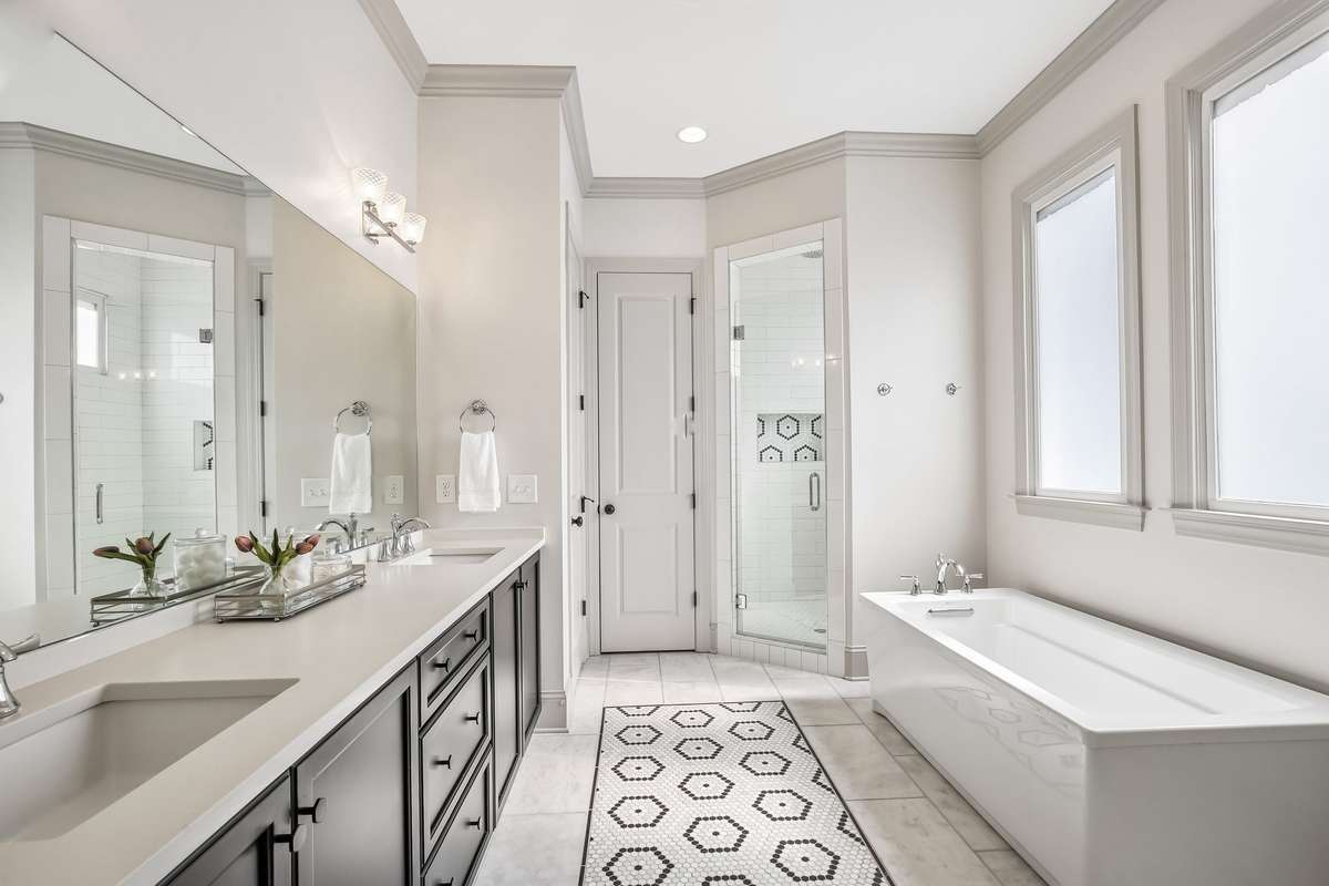 Primary bath with soaking tub, separate shower, and natural light