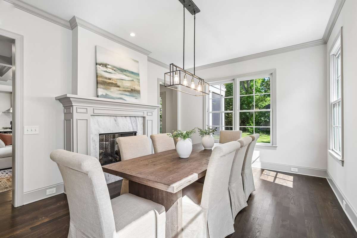 Dining space with fireplace and clean, bright finishes