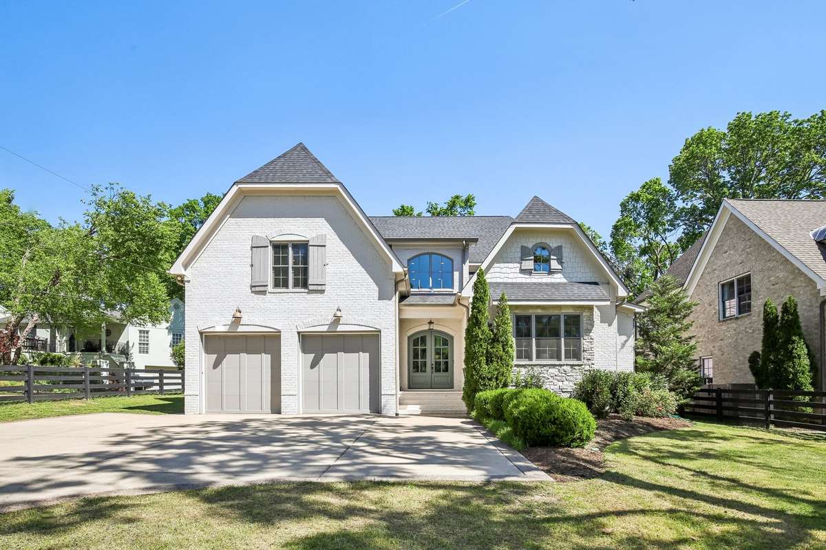 Front view showcasing full facade and spacious driveway.