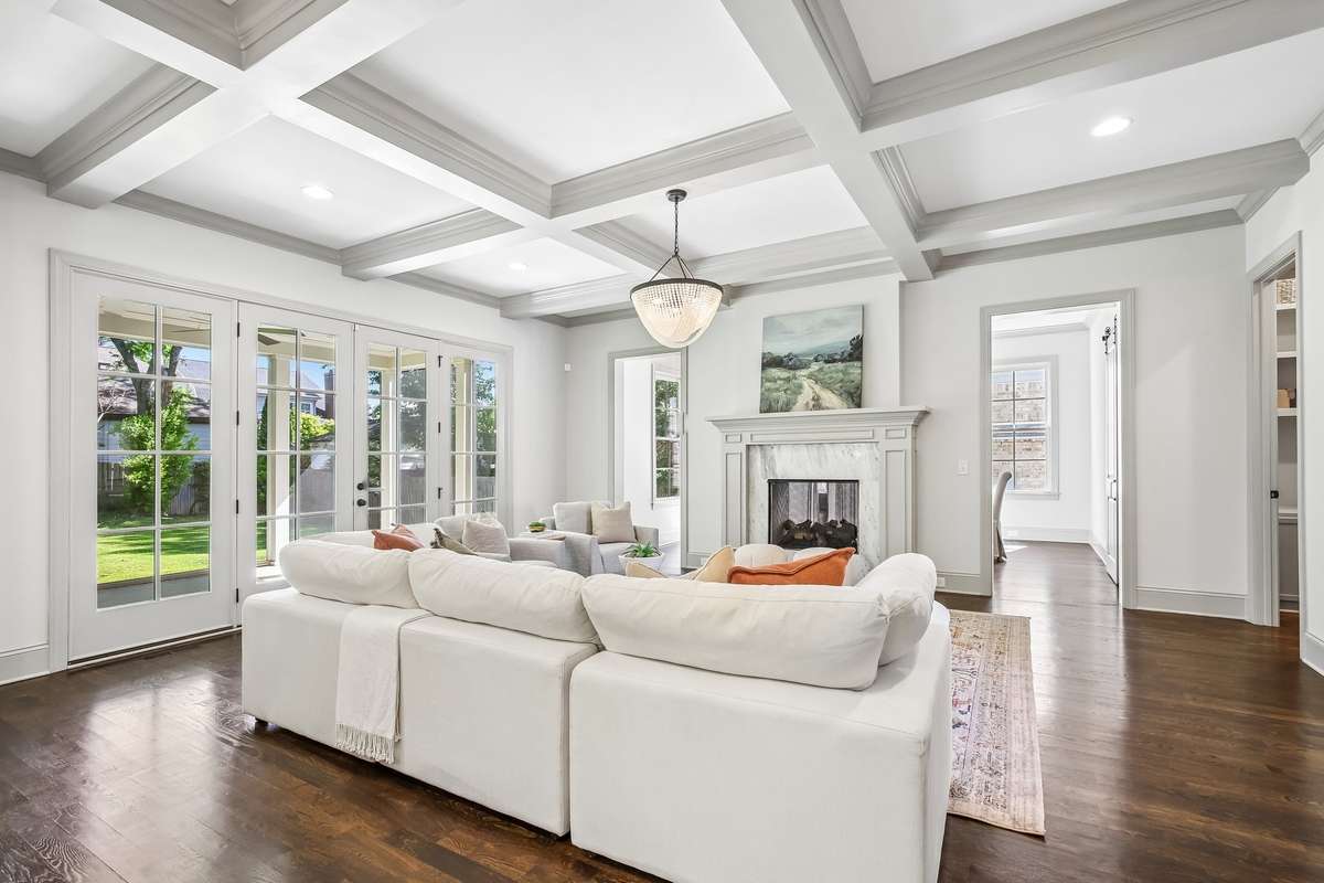 Open living space with coffered ceilings and abundant natural light