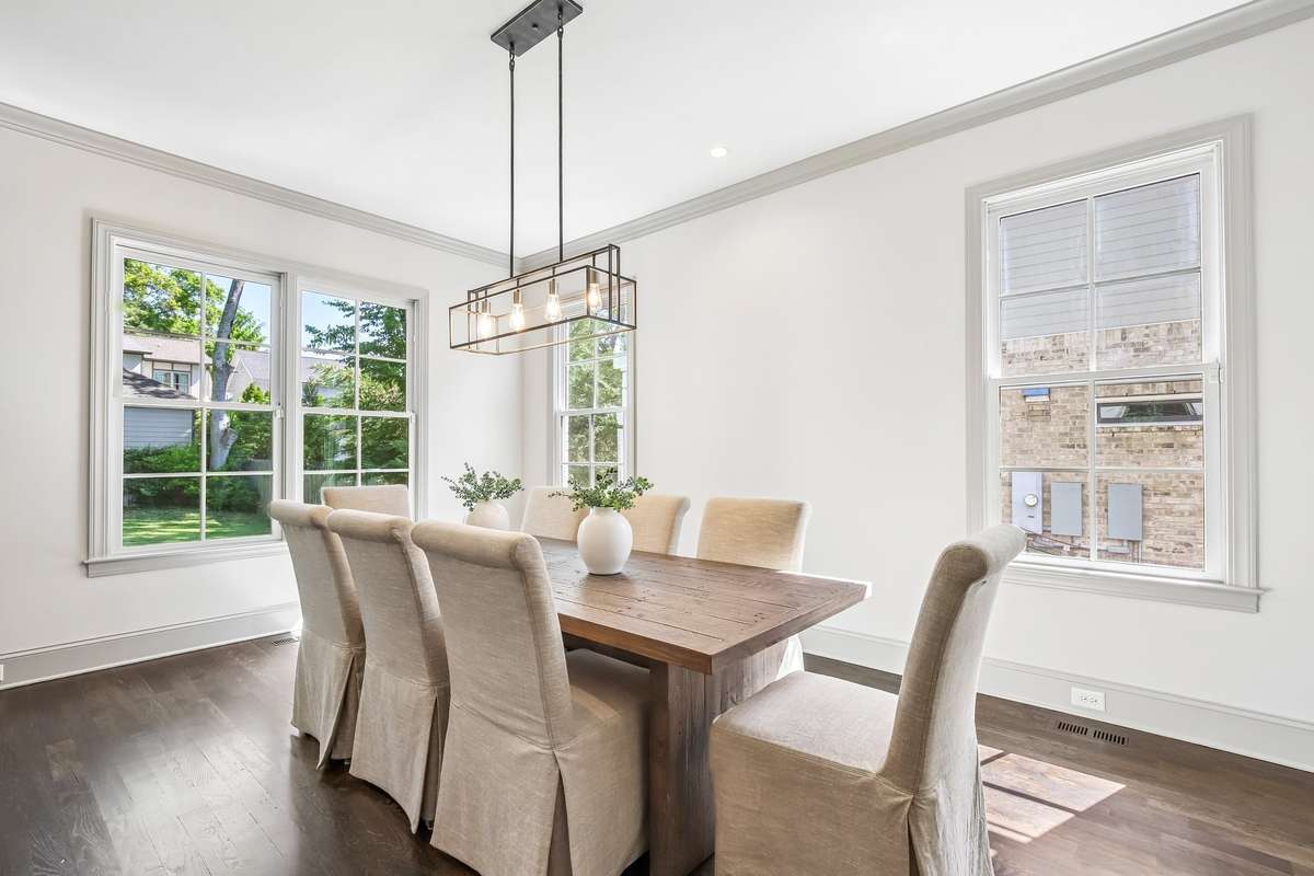 Dining area with large windows and natural light, perfect for hosting