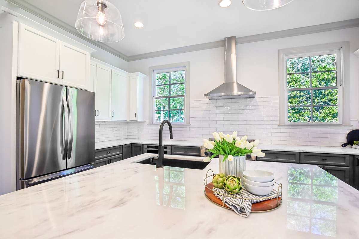 Marble island with prep sink and clean, modern finishes