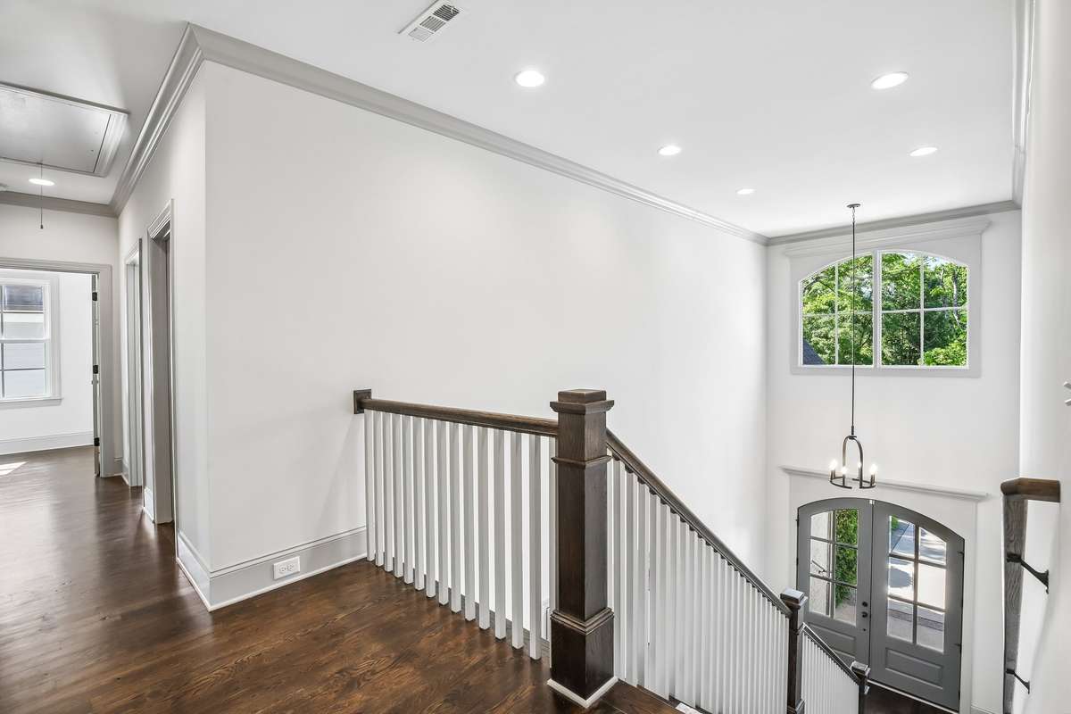 Upper landing with open railing and natural light