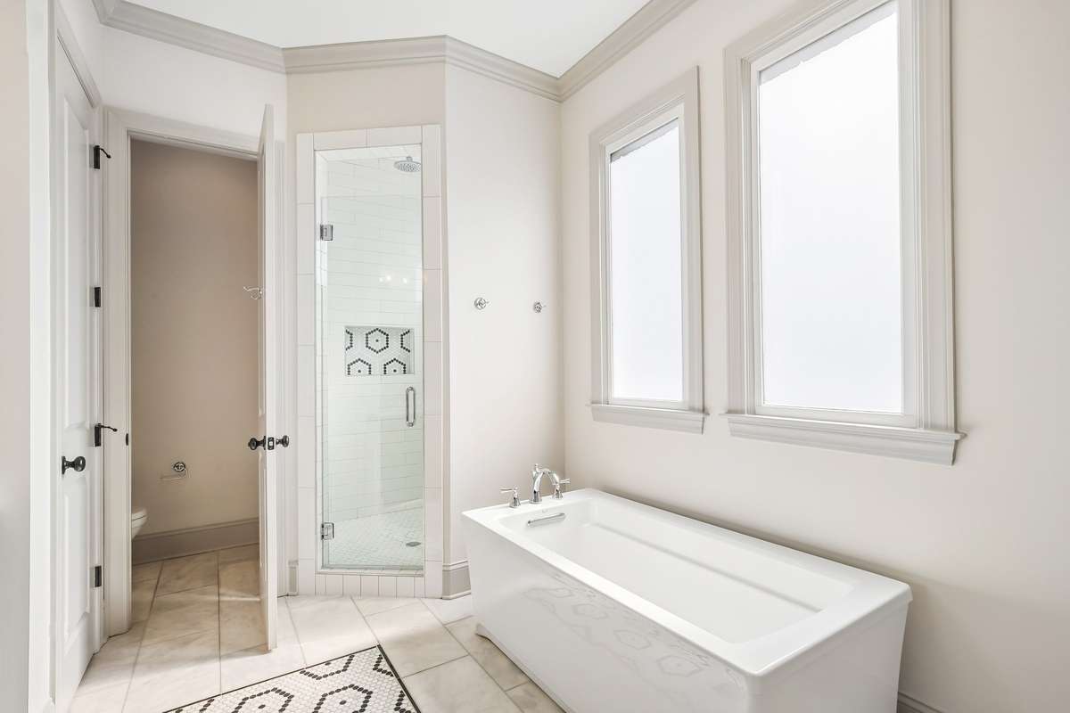 Soaking tub with natural light and glass-enclosed shower