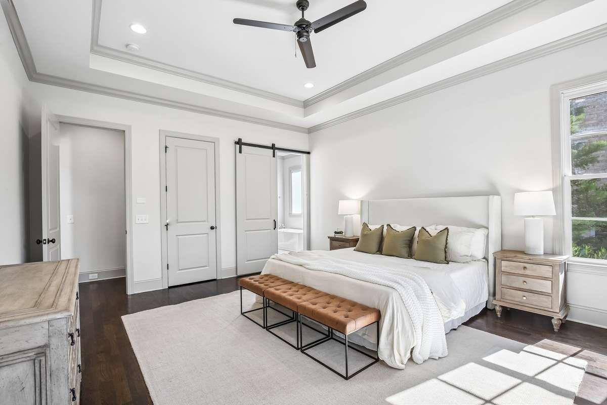 Primary suite with hardwood floors and clean, bright finishes