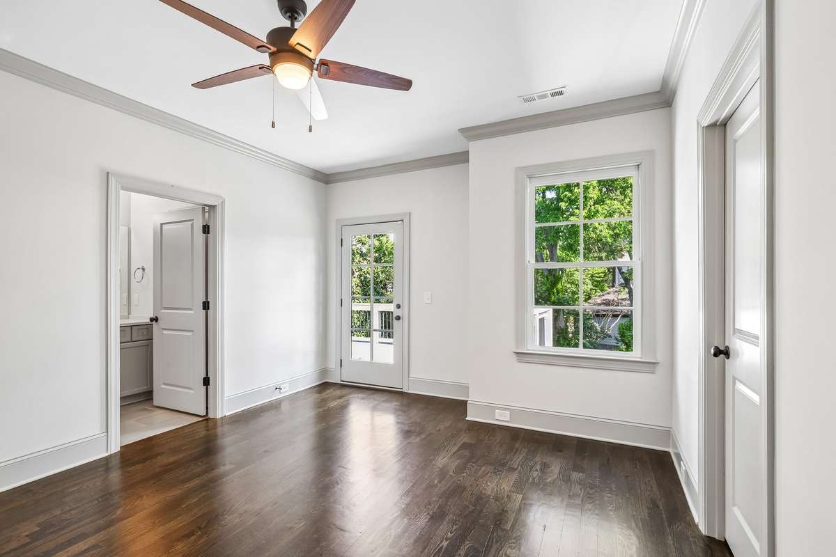 Bedroom with multiple windows and open to a back deck