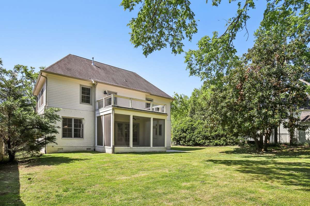 Rear exterior with screened-in patio and upper deck