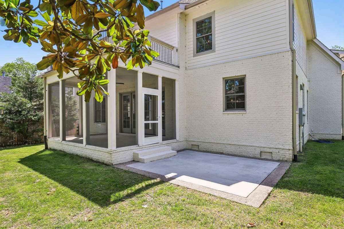 Rear exterior with screened-in patio and upper deck overlooking the backyard