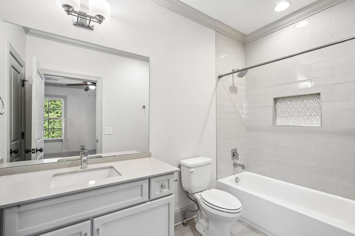 Full bath with tile surround and clean finishes