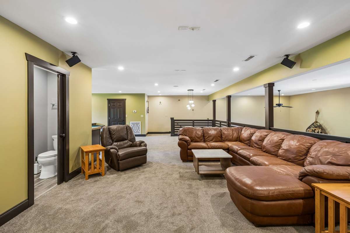 Large bonus/recreation room with ample seating, ideal for gatherings, game nights, or additional living space.