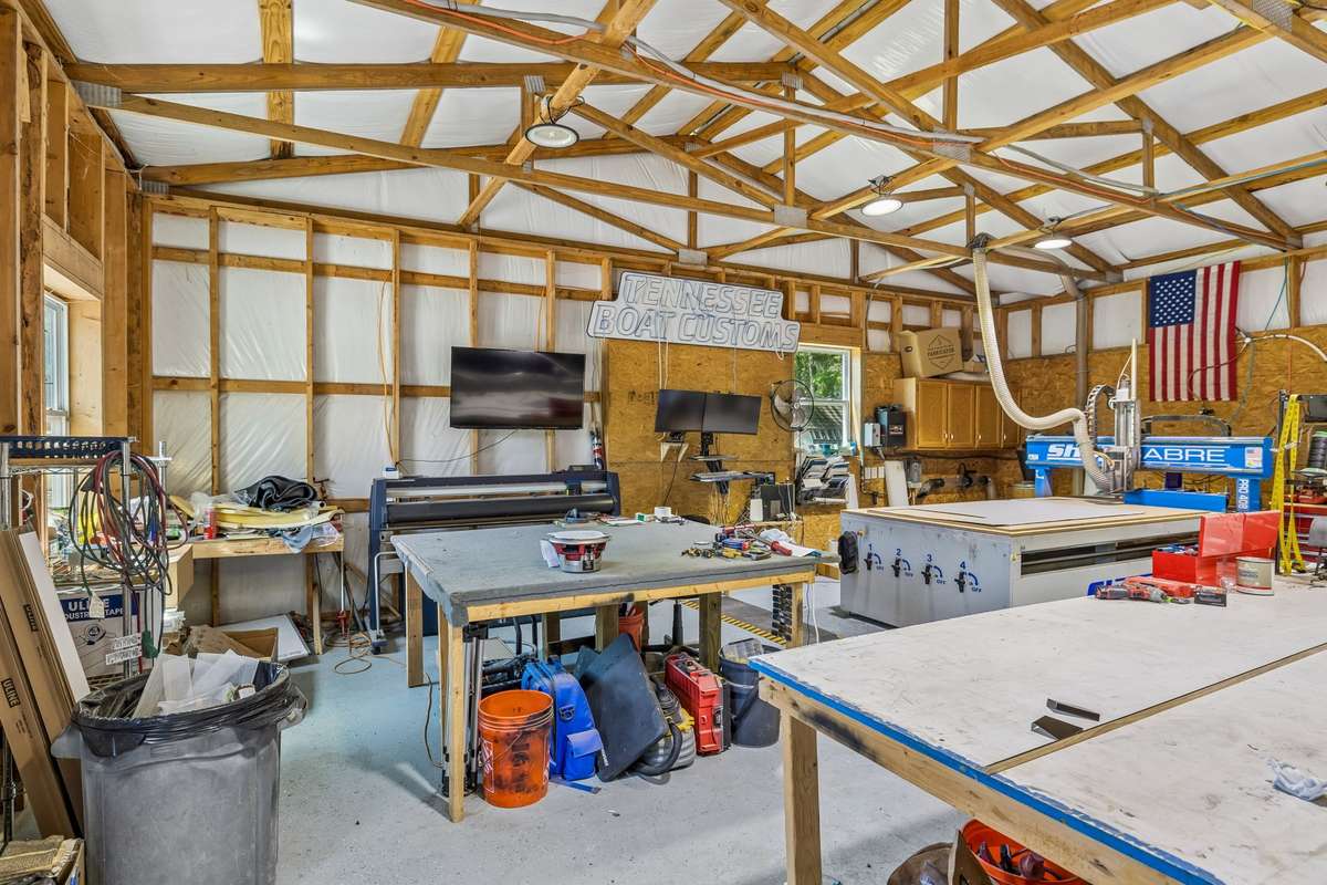 Spacious, heated and cooled shop equipped for hobbies or business use, offering ample workspace and storage.