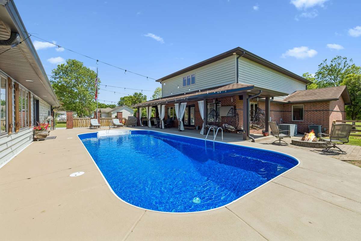 Private backyard oasis featuring an in-ground pool, spacious patio, and covered outdoor living area perfect for relaxing or entertaining.