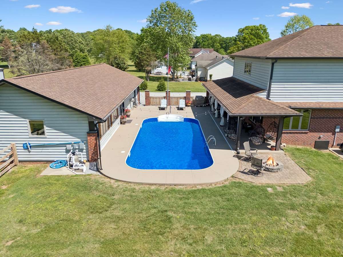 Alternate aerial view of the pool courtyard highlighting the seamless connection between the main home and outdoor living spaces.