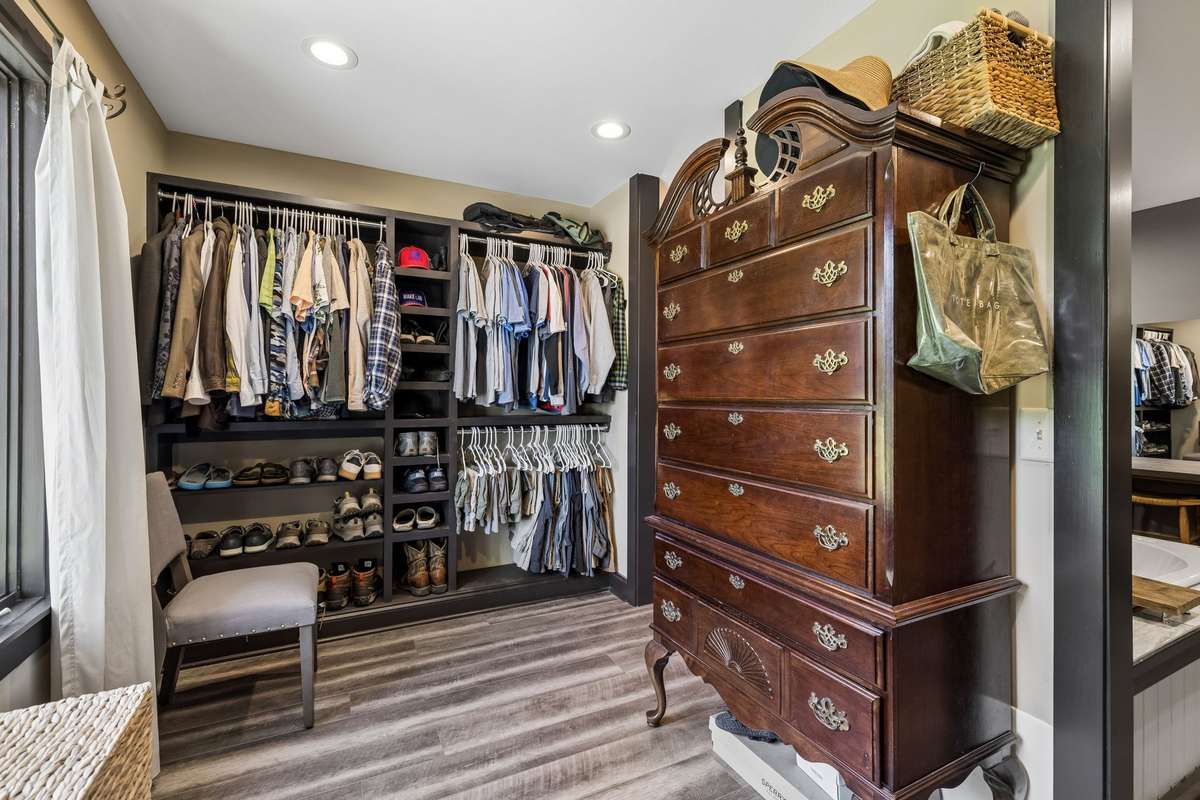Custom walk-in closet with built-in shelving makes organization easy