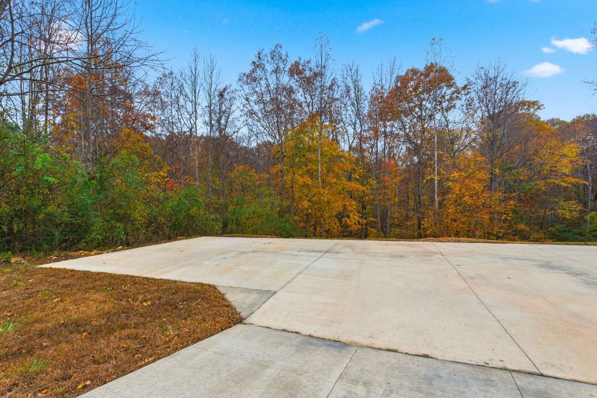 Large concreted area in front of the garage.