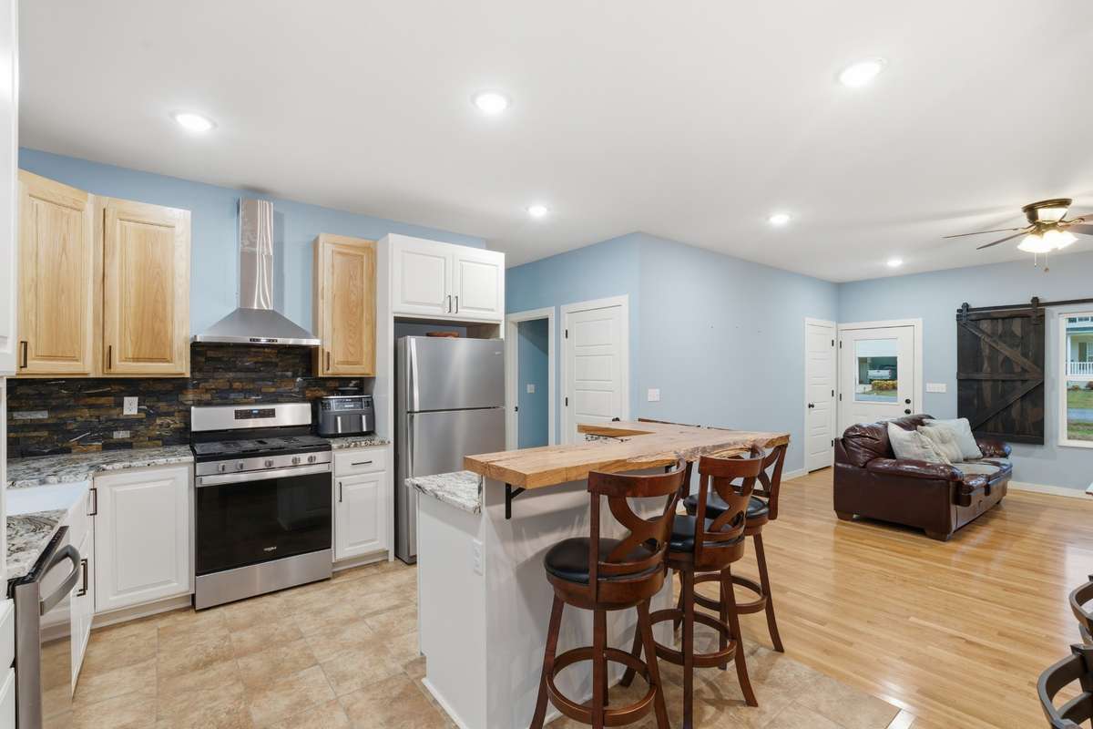 Den is to your right and Bedroom #2 & #3 is to your left past fridge.