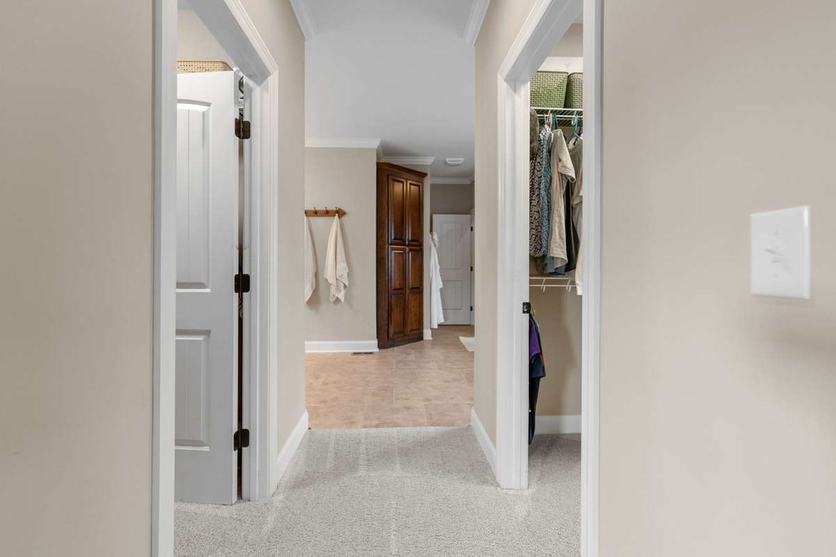 Master bedroom leads into the ensuite master bath with his and her walk-in closets on either side of the entryway.