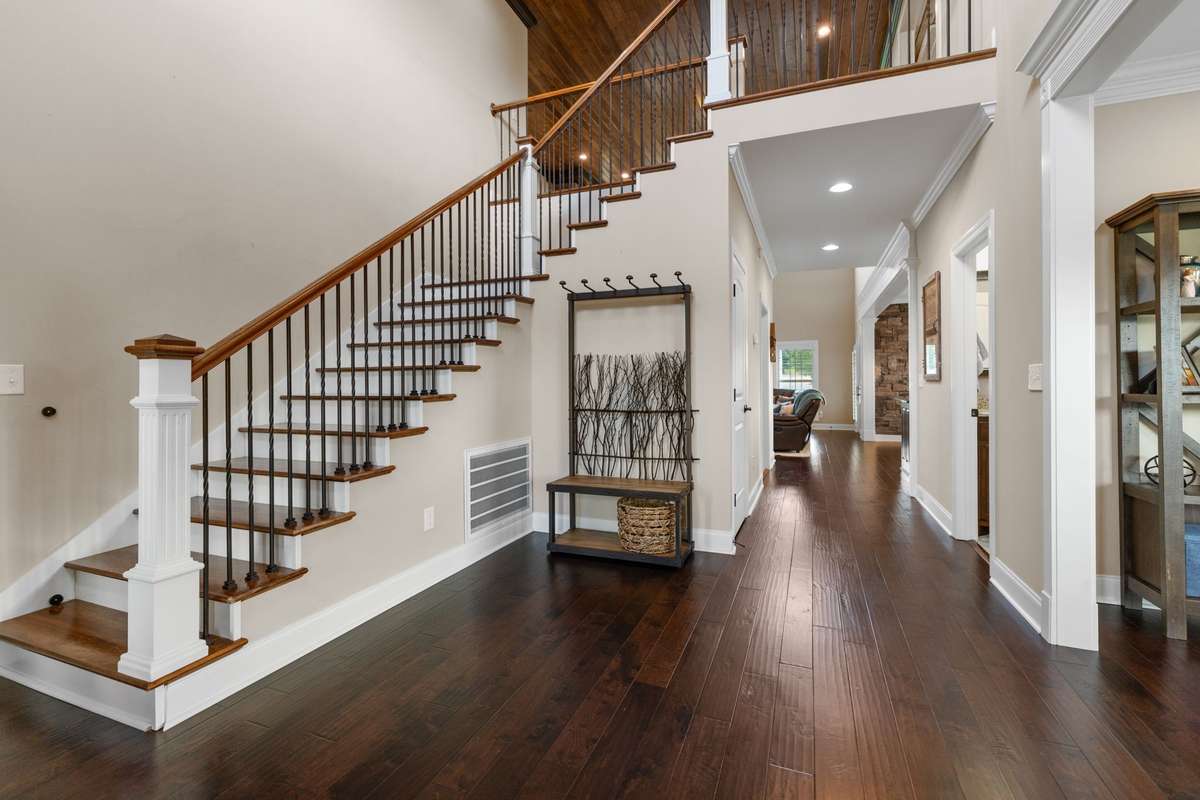 Grand foyer with timeless feature staircase.