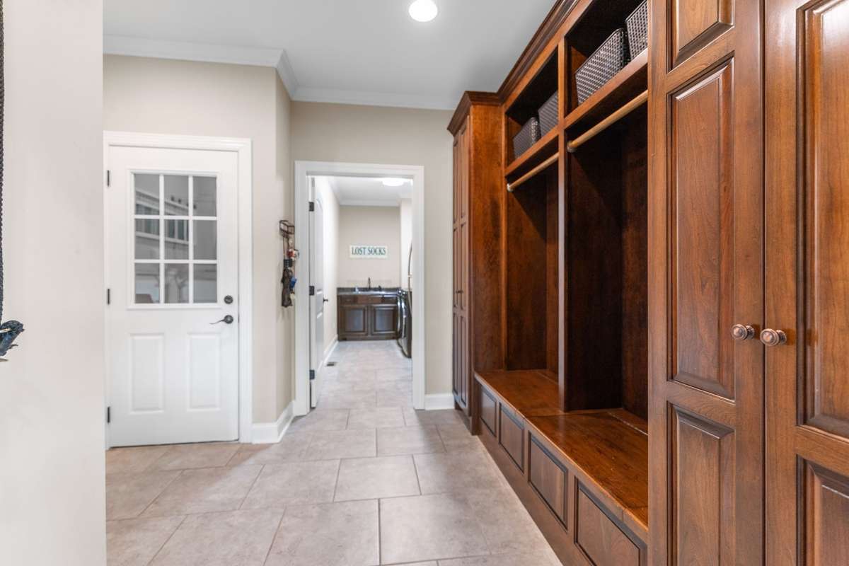 Off the garage and leading to the laundry room, you have a mudroom with beautiful cabinetry and locker storage.